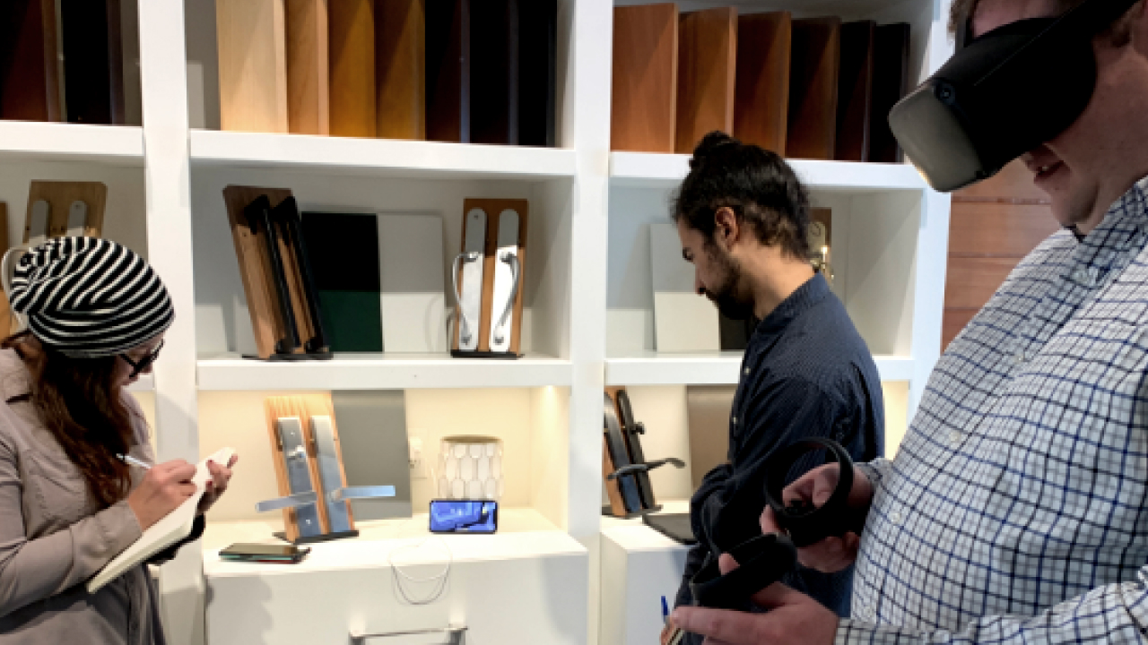 Colleagues observe the live feed of an architect interacting in the VR experience