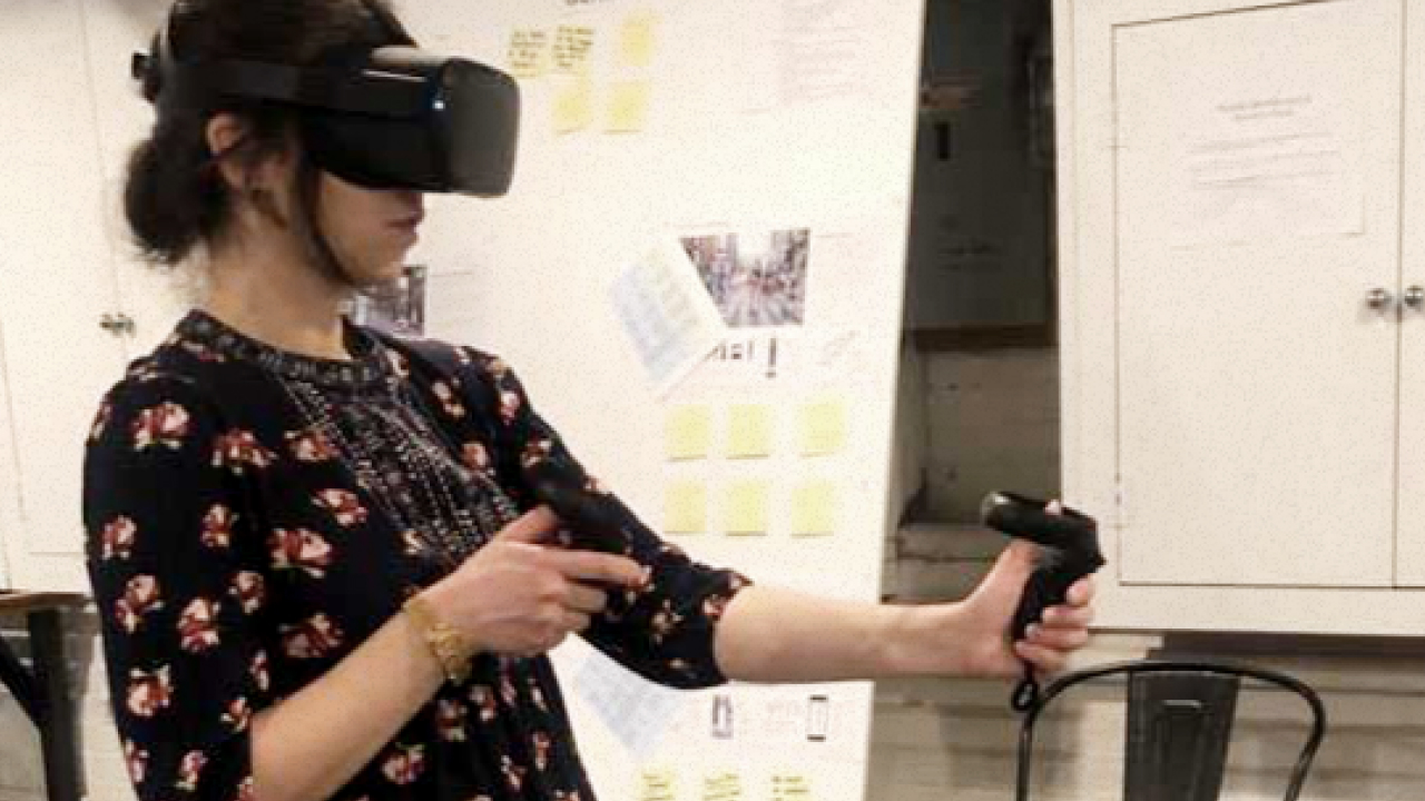 An Architect uses her controls to interact with model windows.
